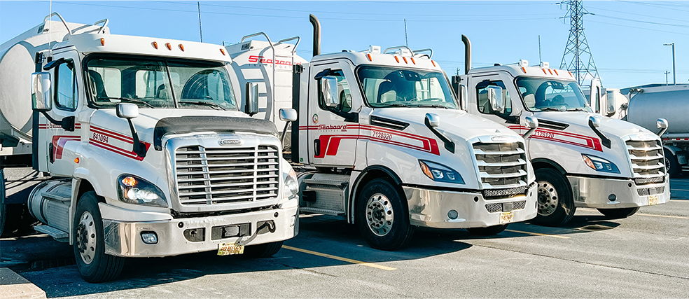 Closeup of parked Seaboard Transport Group cabs and tanker trailers